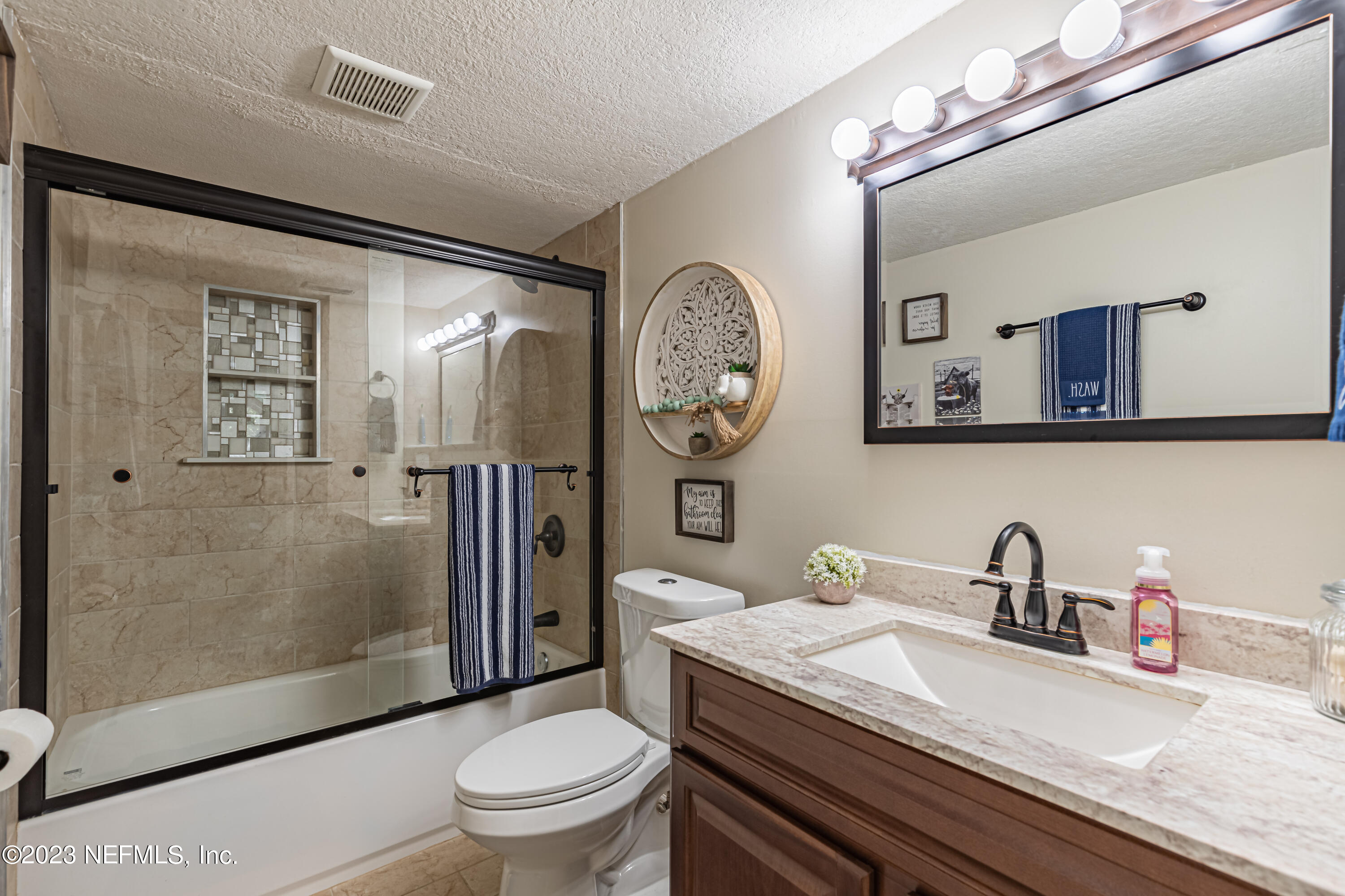 2036 Cornell Road Middleburg, FL 32068 - Photo 13 of 62 a bathroom with a toilet a sink and mirror