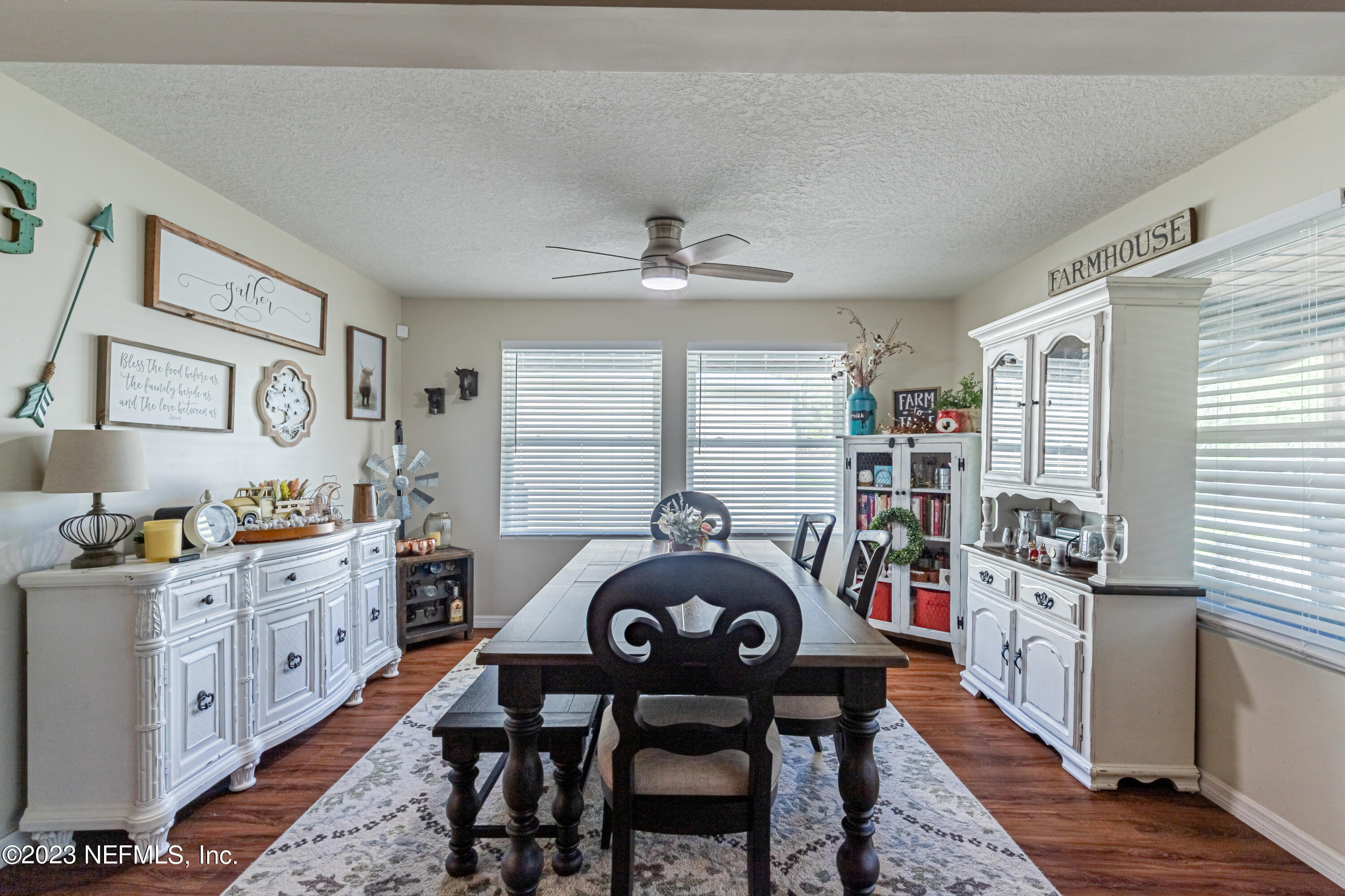 2036 Cornell Road Middleburg, FL 32068 - Photo 19 of 62 a kitchen with a table chairs a stove a window and cabinets