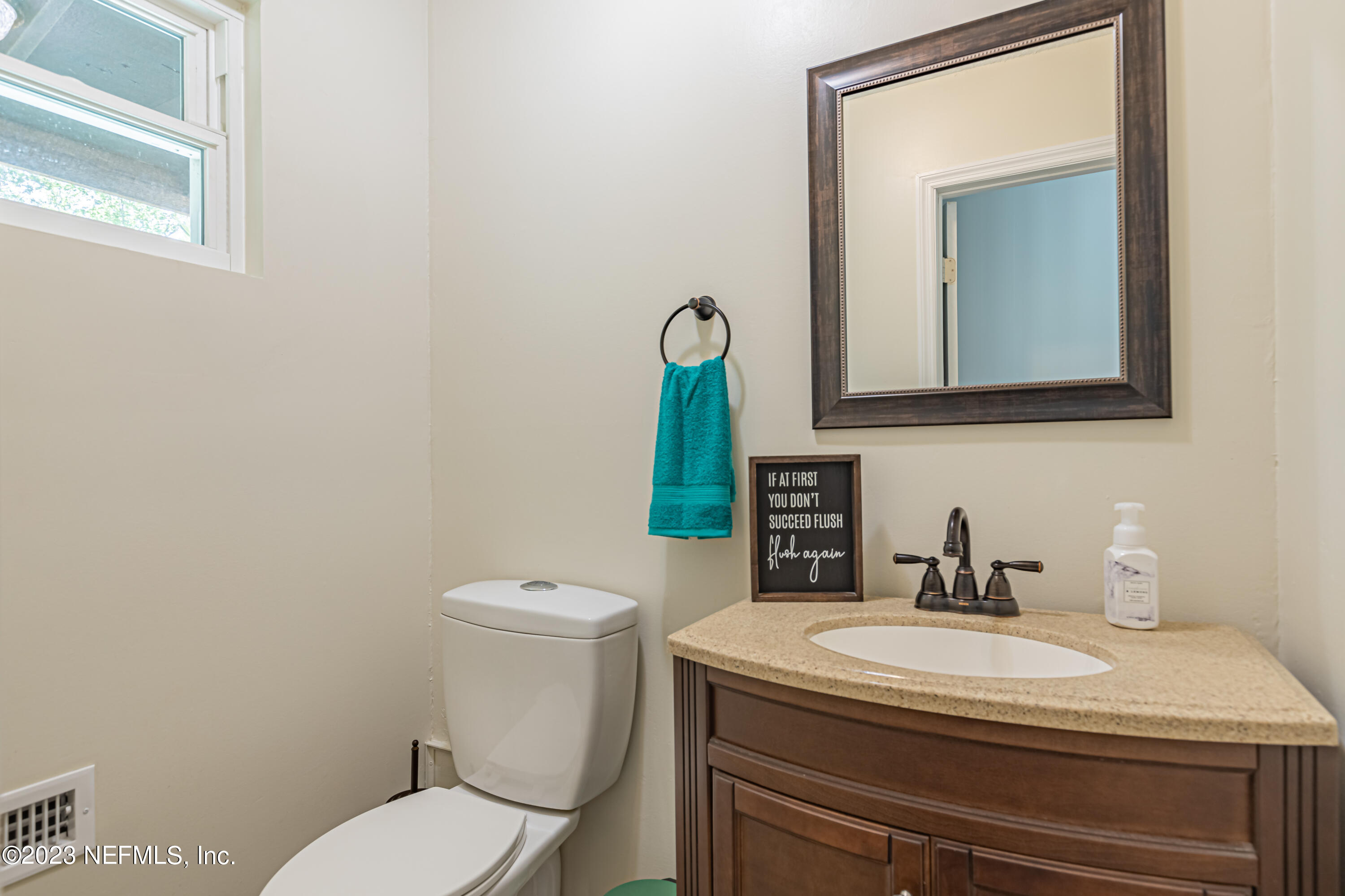 2036 Cornell Road Middleburg, FL 32068 - Photo 29 of 62 a bathroom with a toilet sink and mirror