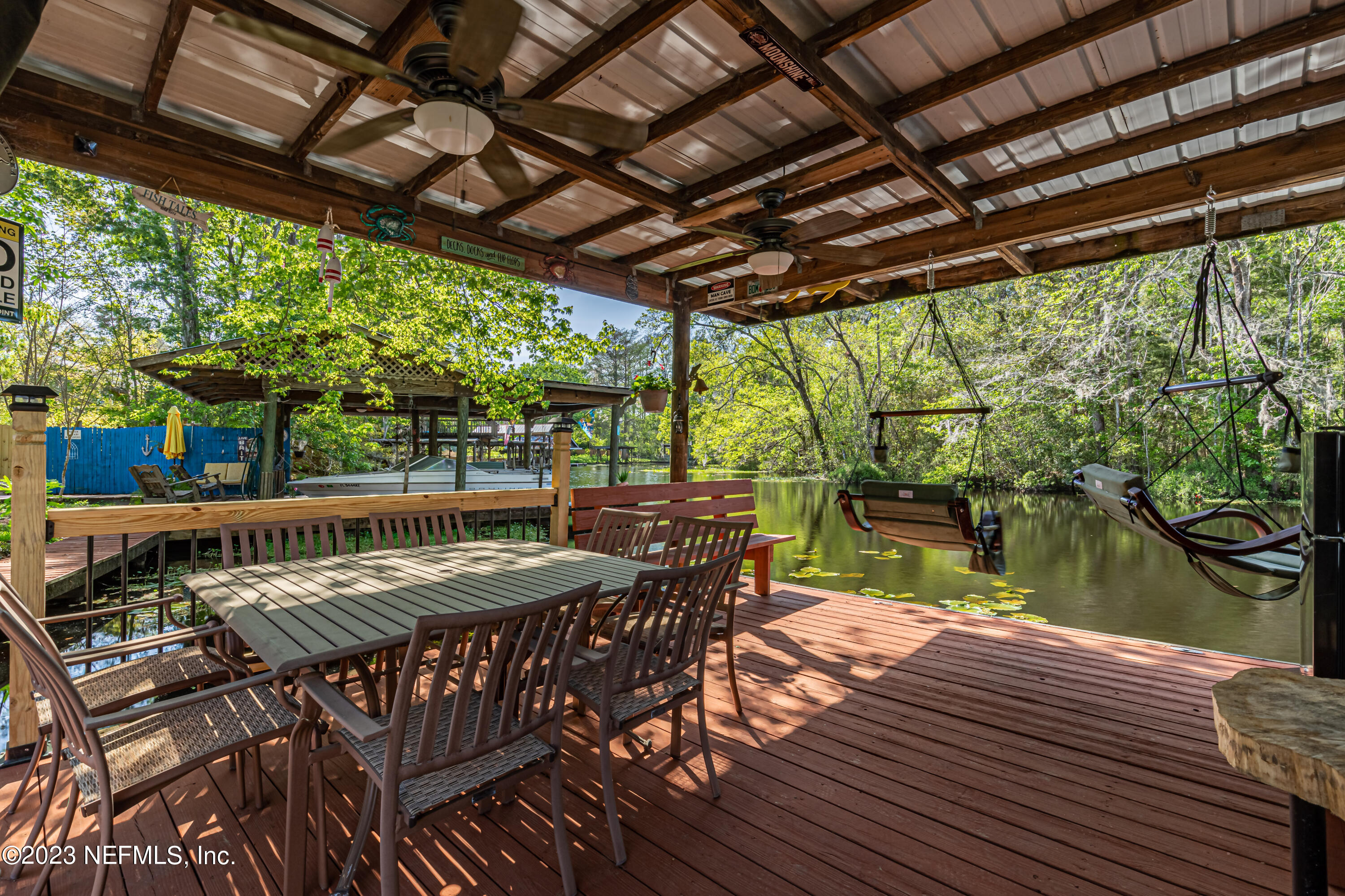2036 Cornell Road Middleburg, FL 32068 - Photo 46 of 62 a view of a patio with table and chairs a barbeque with wooden floor and roof with floor to ceiling window with wooden floor