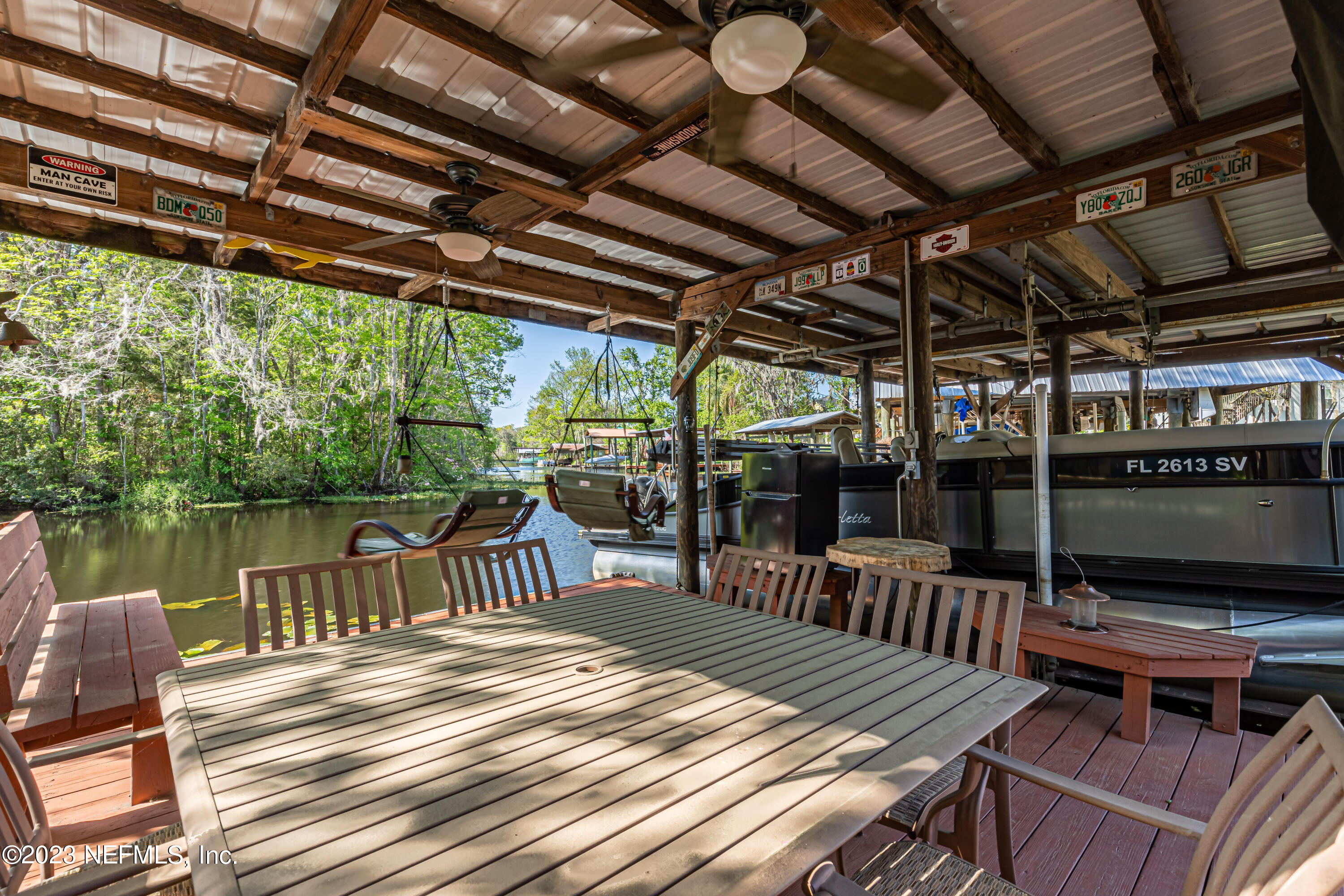 2036 Cornell Road Middleburg, FL 32068 - Photo 47 of 62 a view of a patio with a table chairs and a barbeque
