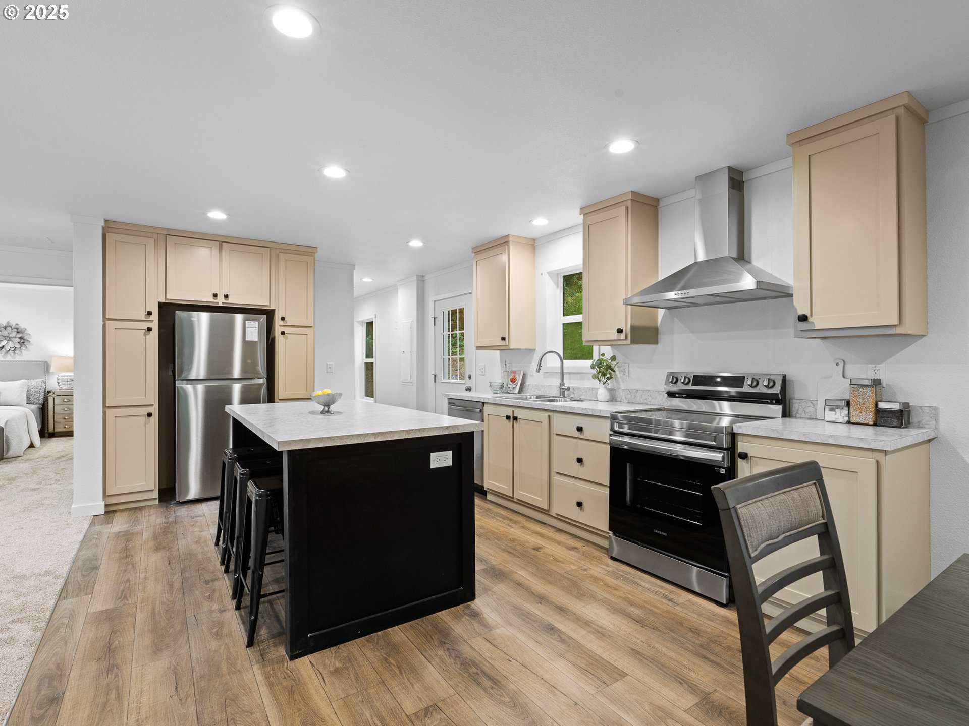 54839 Southwest South Road Gaston, OR 97119 - Photo 4 of 15 a kitchen with stainless steel appliances granite countertop a stove a sink dishwasher a refrigerator and white cabinets with wooden floor