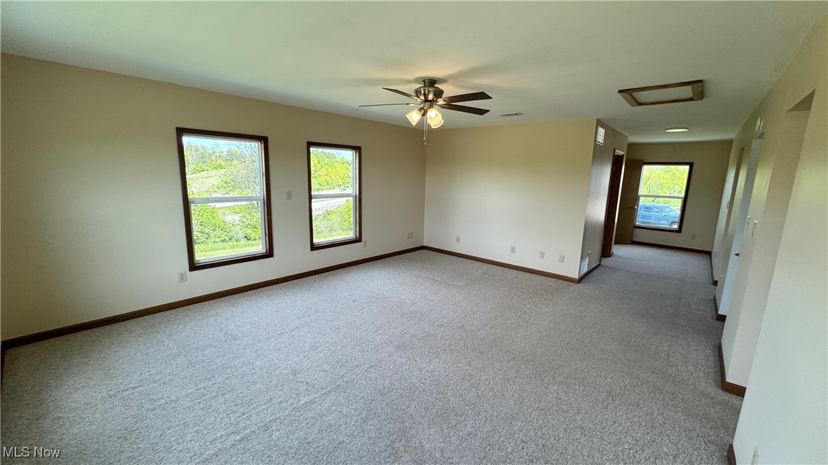 6255 Highland Ridge Road Lowell, OH 45744 - Photo 12 of 40 Empty room with attic access, baseboards, light colored carpet, and a ceiling fan