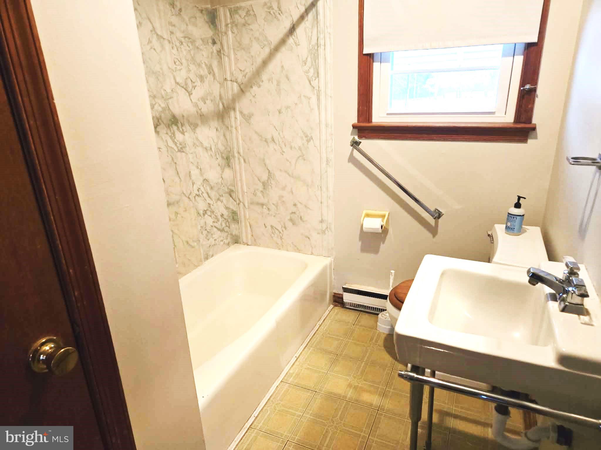 1154 Steamboat Road Shady Side, MD 20764 - Photo 7 of 9 a bathroom with a tub sink and mirror