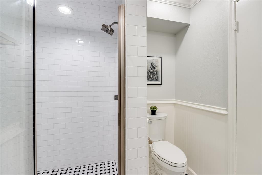 10741 Villager Road, Unit D Dallas, TX 75230 - Photo 16 of 25 Walk-in shower with subway tile surround and black and white penny tile flooring