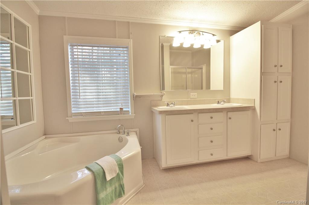 734 Farley Road Fort Mill, SC 29715 - Photo 13 of 23 a spacious bathroom with a tub sink and mirror