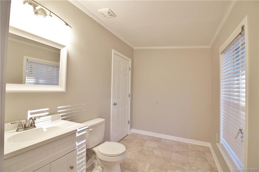 734 Farley Road Fort Mill, SC 29715 - Photo 15 of 23 a bathroom with a sink a toilet a mirror and vanity