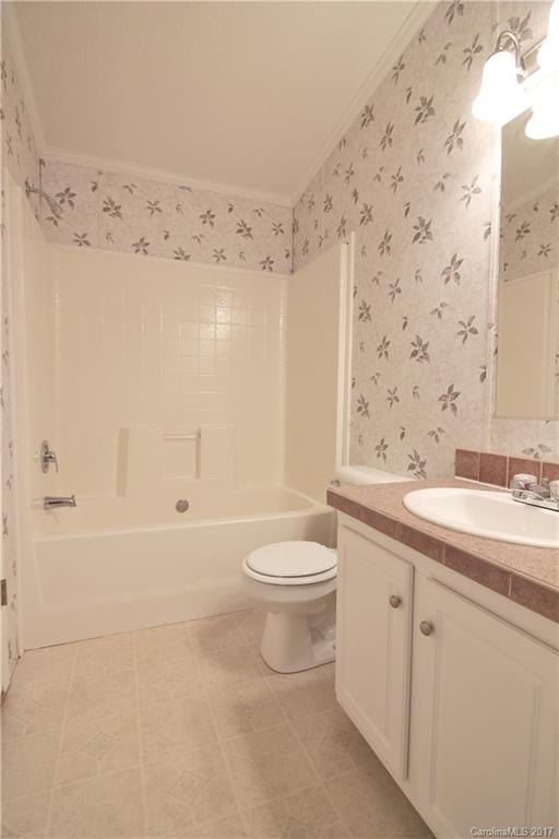 734 Farley Road Fort Mill, SC 29715 - Photo 17 of 23 a bathroom with a granite countertop sink a toilet and shower