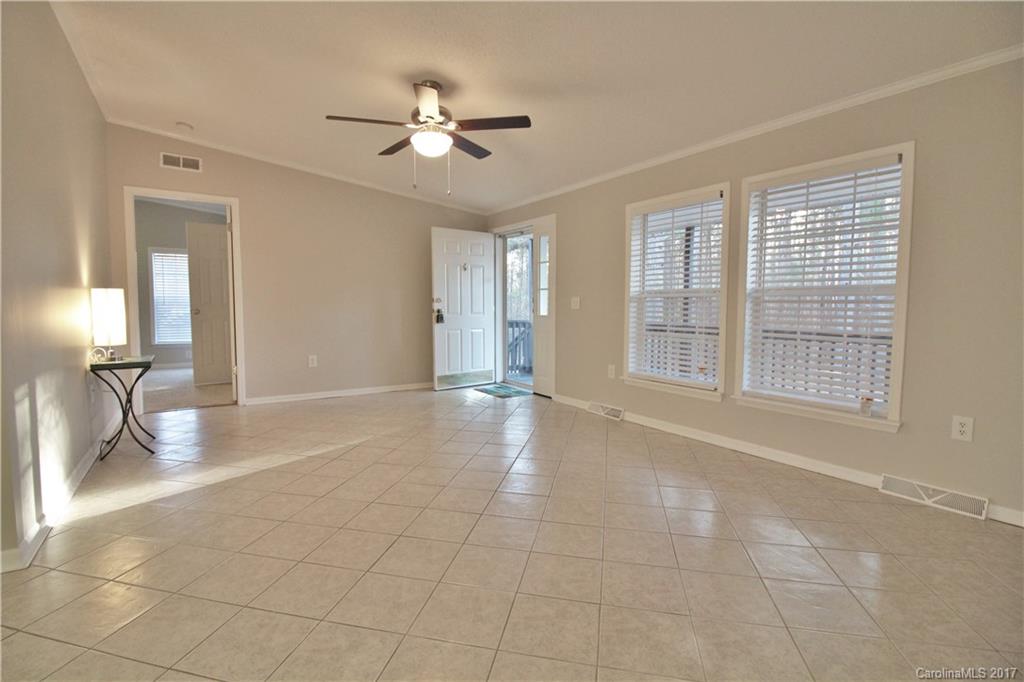 734 Farley Road Fort Mill, SC 29715 - Photo 10 of 23 a view of an empty room with a chandelier fan and fire place