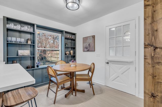 a view of a dining room with furniture and window