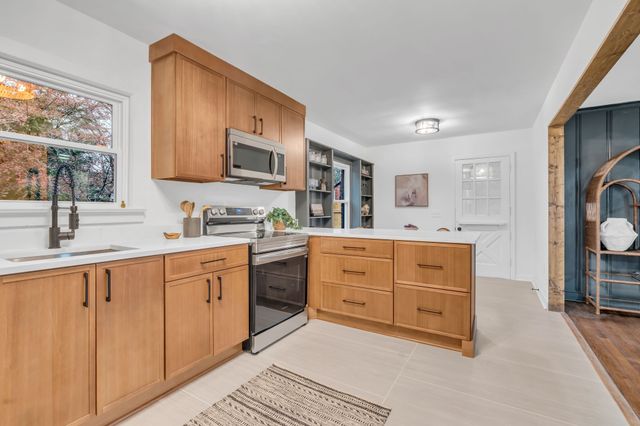 a spacious bathroom with a granite countertop sink mirror and