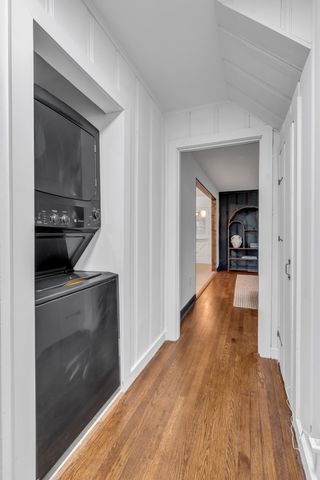 a view of a hallway view with wooden floor and staircase