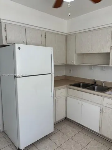 a white refrigerator freezer sitting inside of a kitchen