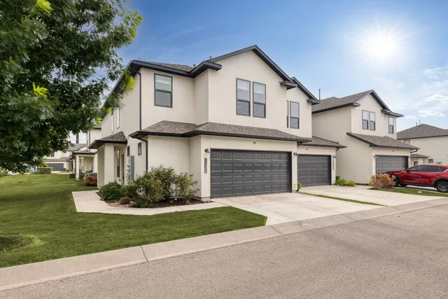 a front view of a house with a garden and yard