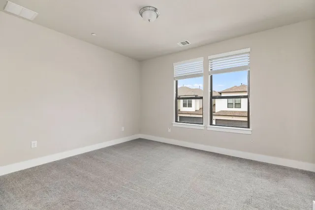 a view of an empty room and closet area