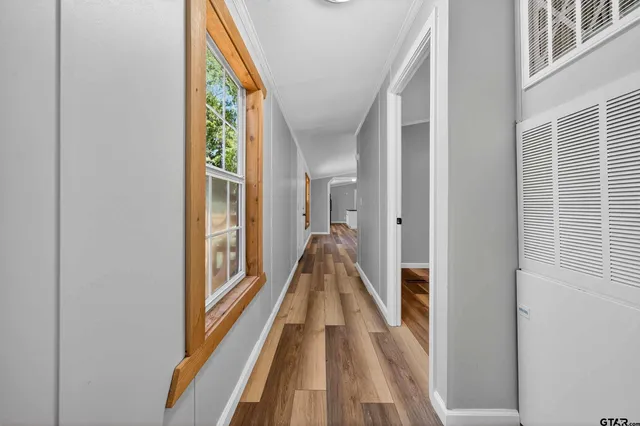 a view of a hallway with wooden floor