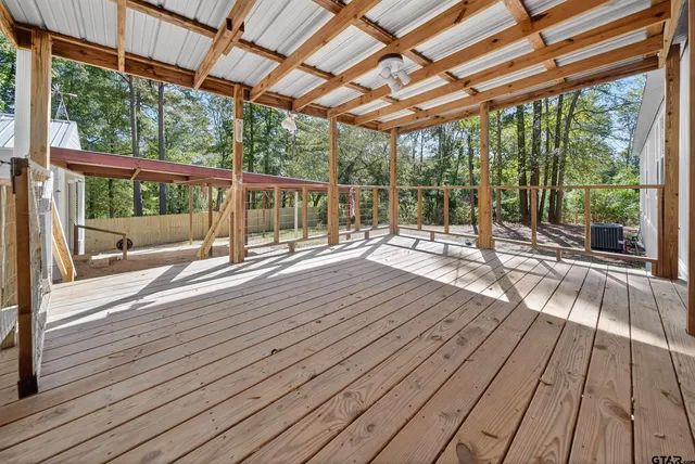 a house with wooden floor next to a patio