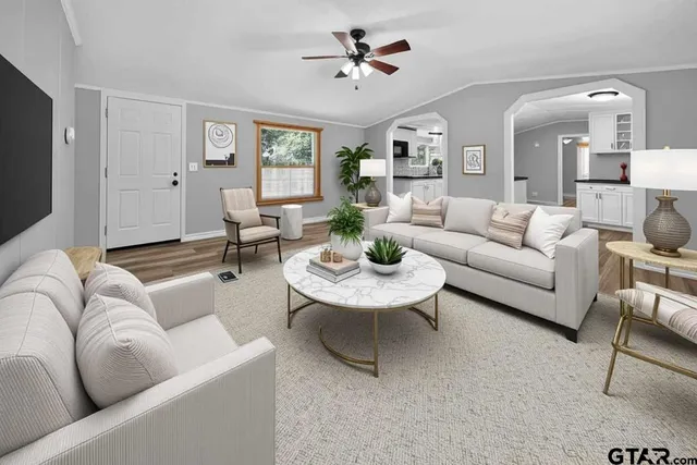 a living room with furniture a large window and a flat screen tv