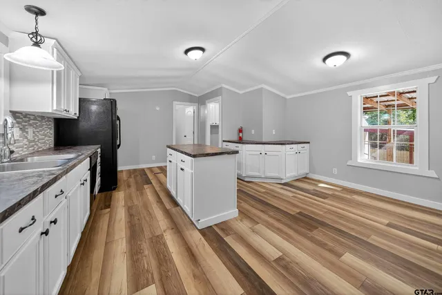 a kitchen with a sink stove and cabinets
