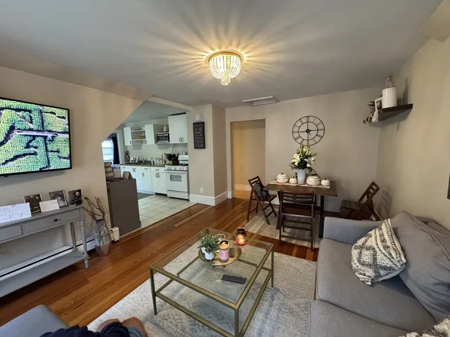 a living room with furniture and a chandelier