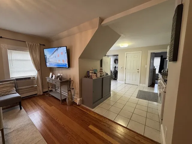 a view of a living room with furniture and a flat screen tv