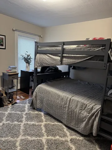 a bedroom with a bed and a lamp on table