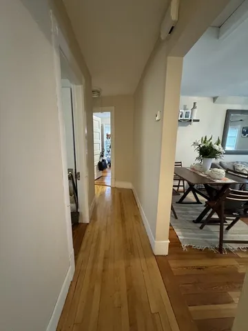a view of a room with wooden floor and furniture