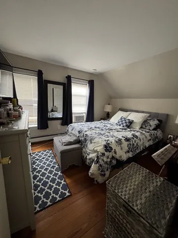 a bedroom with bed couch and window