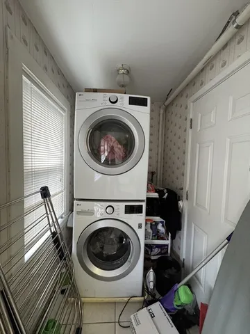 a utility room with sink dryer and washer
