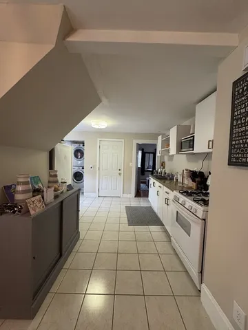 a large kitchen with a stove a sink dishwasher and a refrigerator