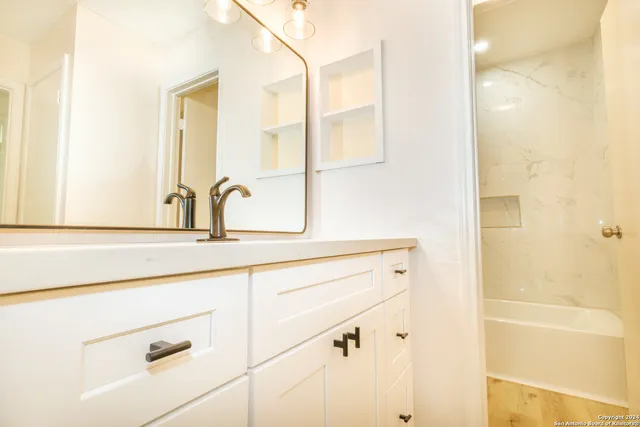 a bathroom with a sink and a mirror