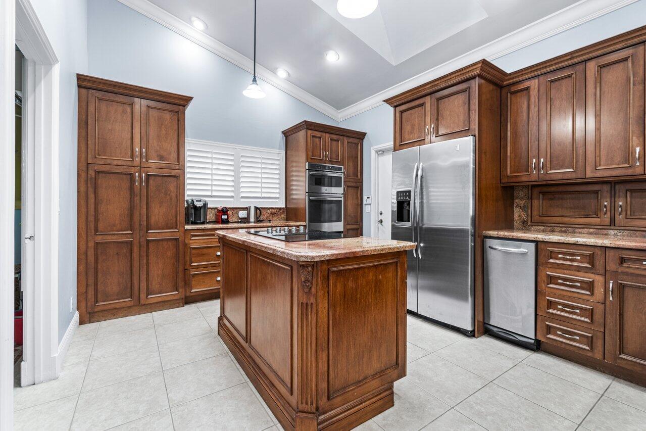 4335 Bocaire Boulevard Boca Raton, FL 33487 - Photo 11 of 55 a kitchen with stainless steel appliances granite countertop a stove a refrigerator and a sink