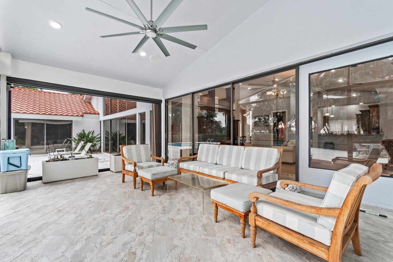 4335 Bocaire Boulevard Boca Raton, FL 33487 - Photo 15 of 55 a living room with furniture large window and a chandelier