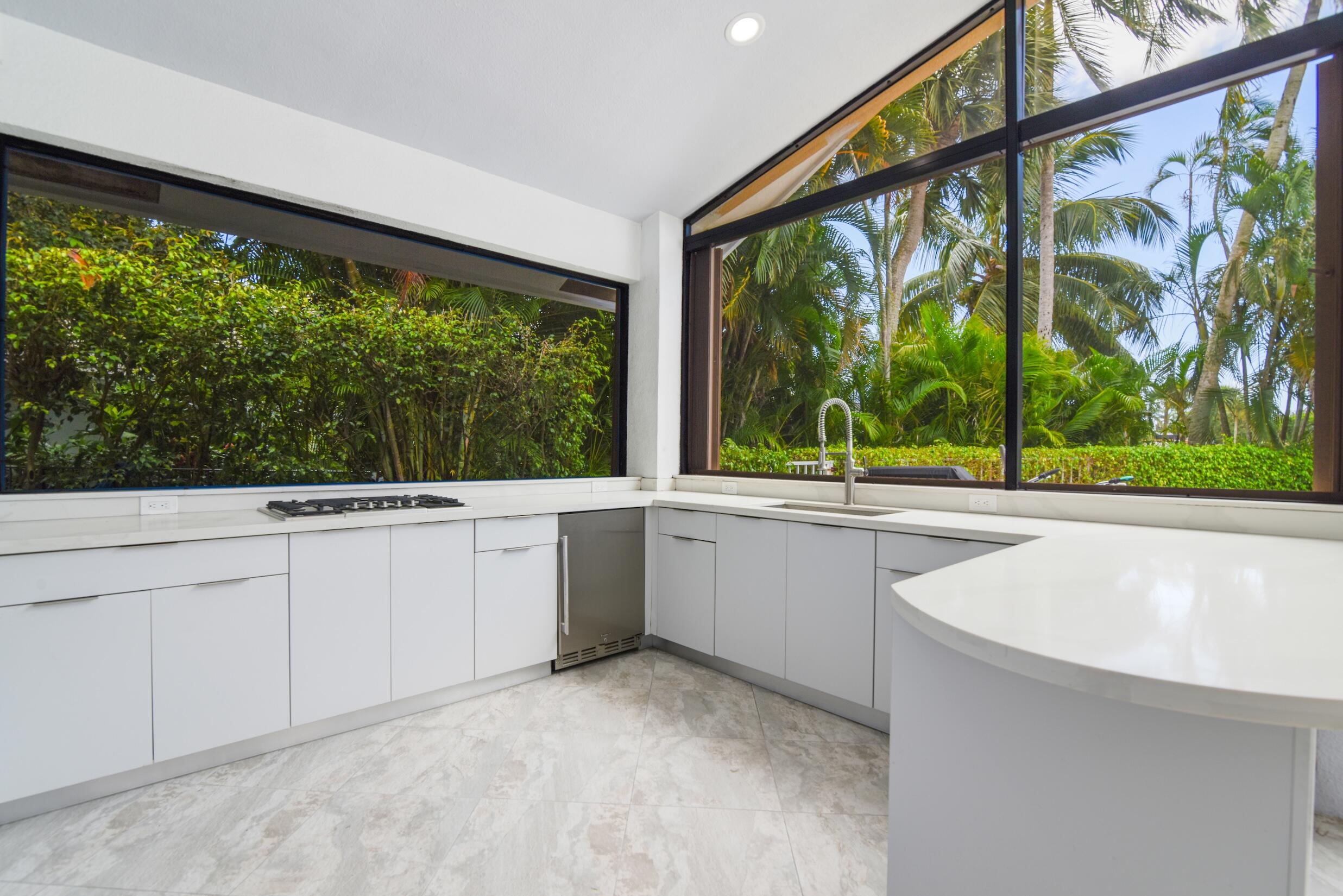 4335 Bocaire Boulevard Boca Raton, FL 33487 - Photo 17 of 55 a view of a kitchen with a sink and wooden floor
