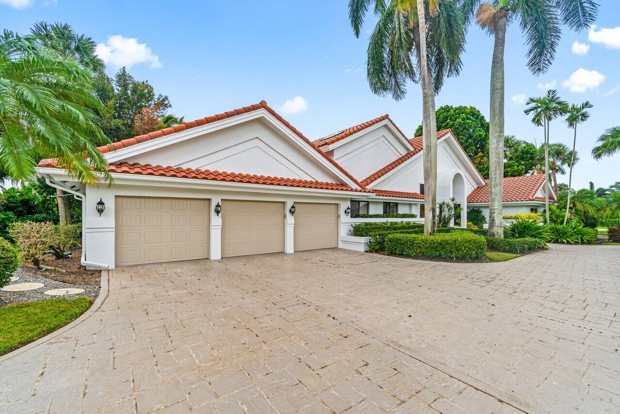 4335 Bocaire Boulevard Boca Raton, FL 33487 - Photo 2 of 55 a view of a house with a yard and palm trees
