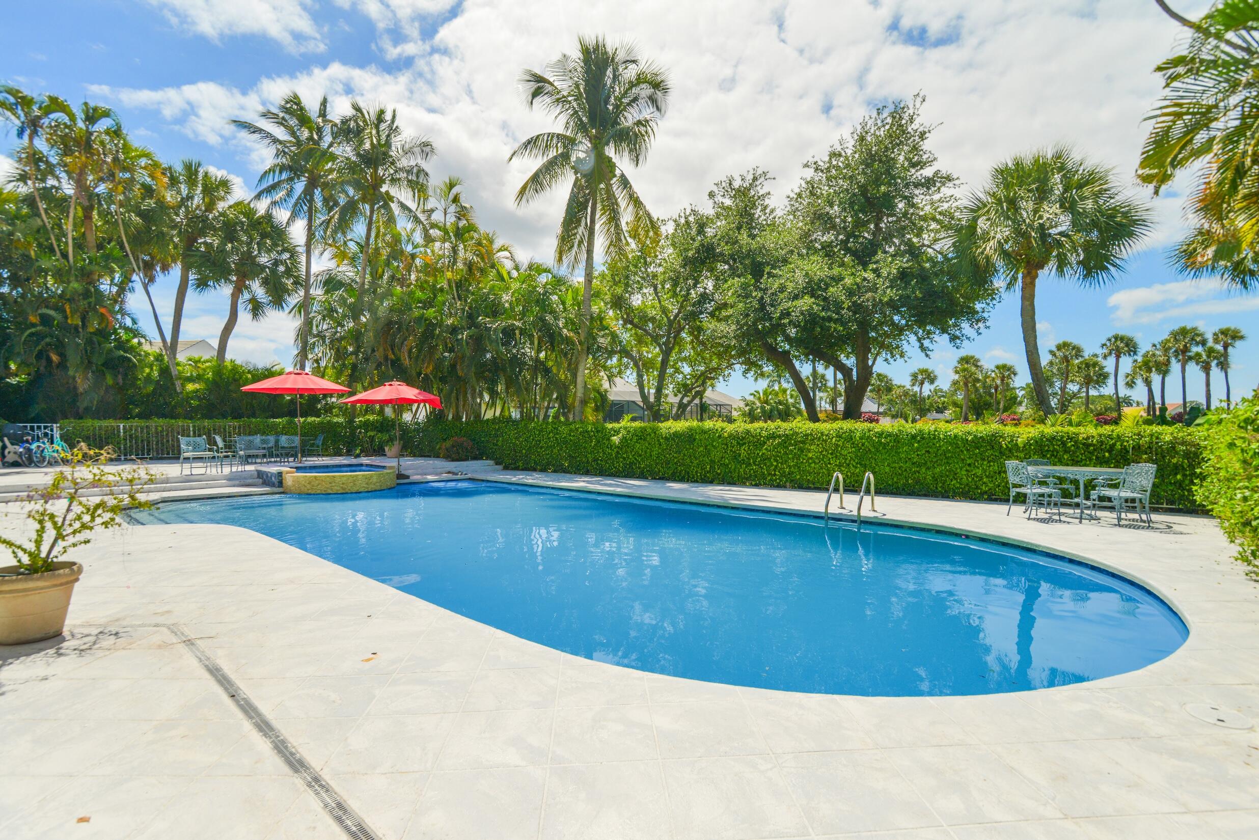 4335 Bocaire Boulevard Boca Raton, FL 33487 - Photo 22 of 55 a view of a swimming pool and trees in the background