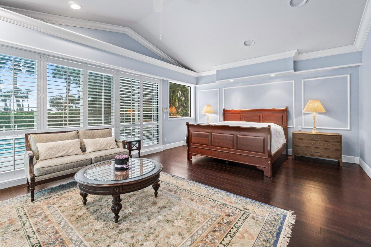 4335 Bocaire Boulevard Boca Raton, FL 33487 - Photo 33 of 55 a bedroom with a bed wooden floor and a table