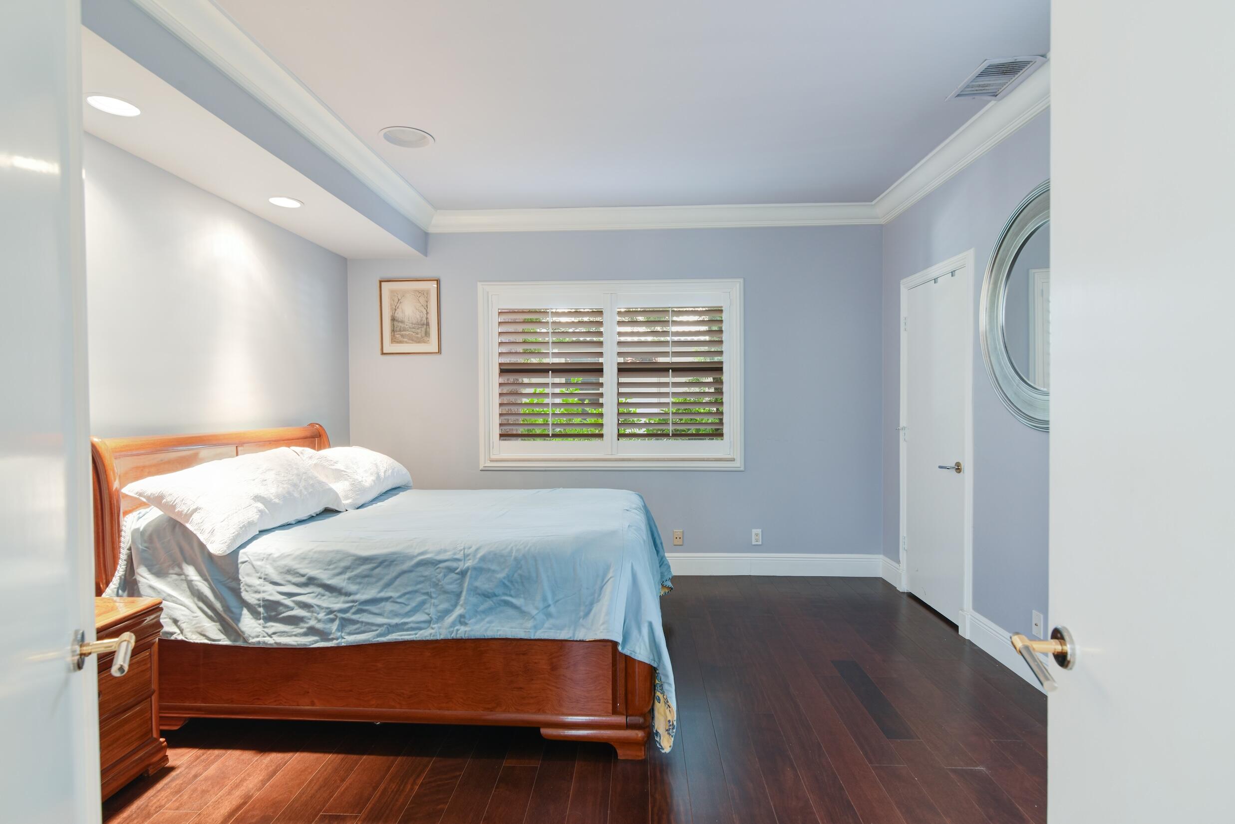 4335 Bocaire Boulevard Boca Raton, FL 33487 - Photo 36 of 55 a bedroom with a bed and wooden floor