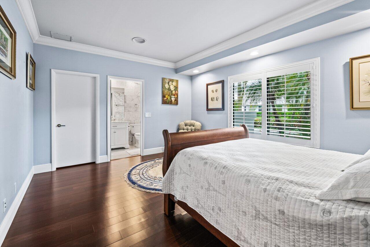 4335 Bocaire Boulevard Boca Raton, FL 33487 - Photo 39 of 55 a bedroom with a bed and wooden floor