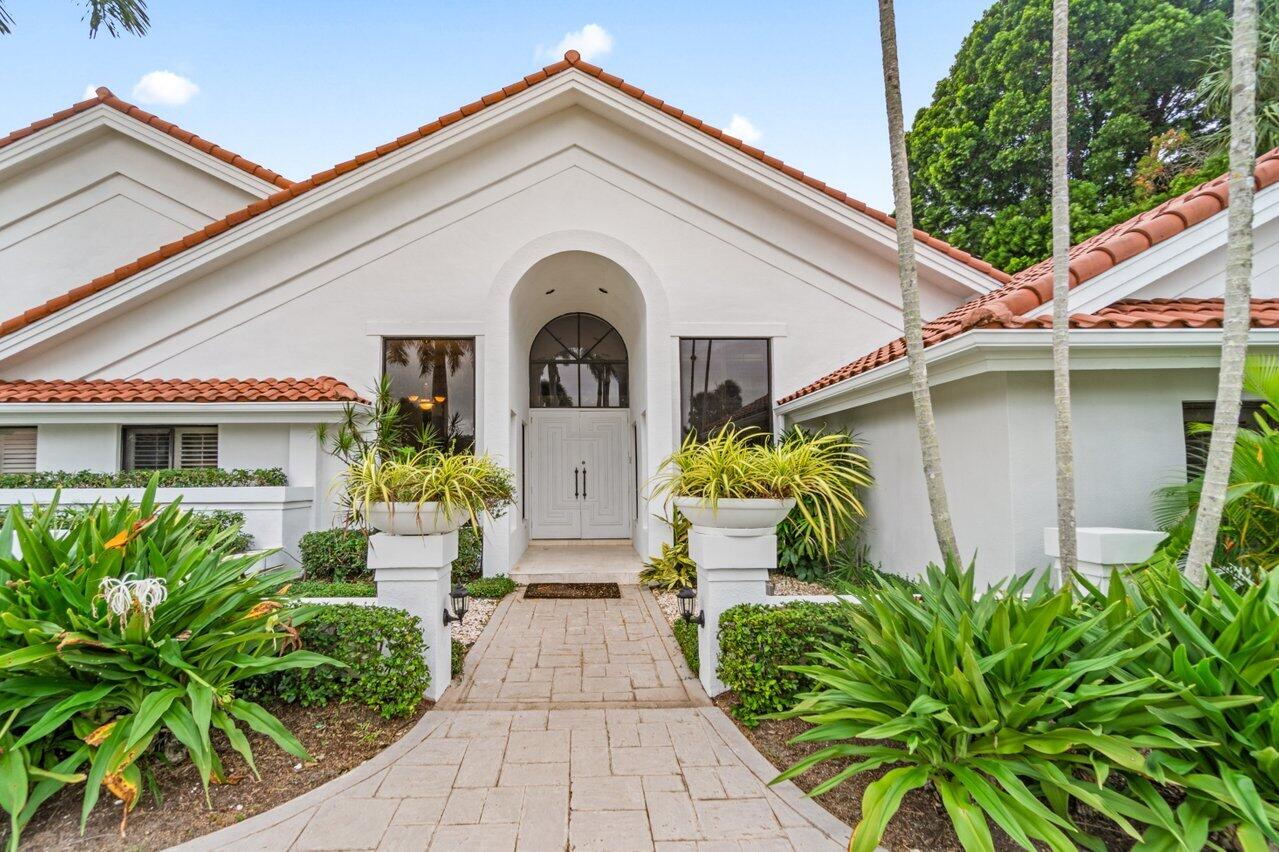4335 Bocaire Boulevard Boca Raton, FL 33487 - Photo 4 of 55 a front view of a house with a garden