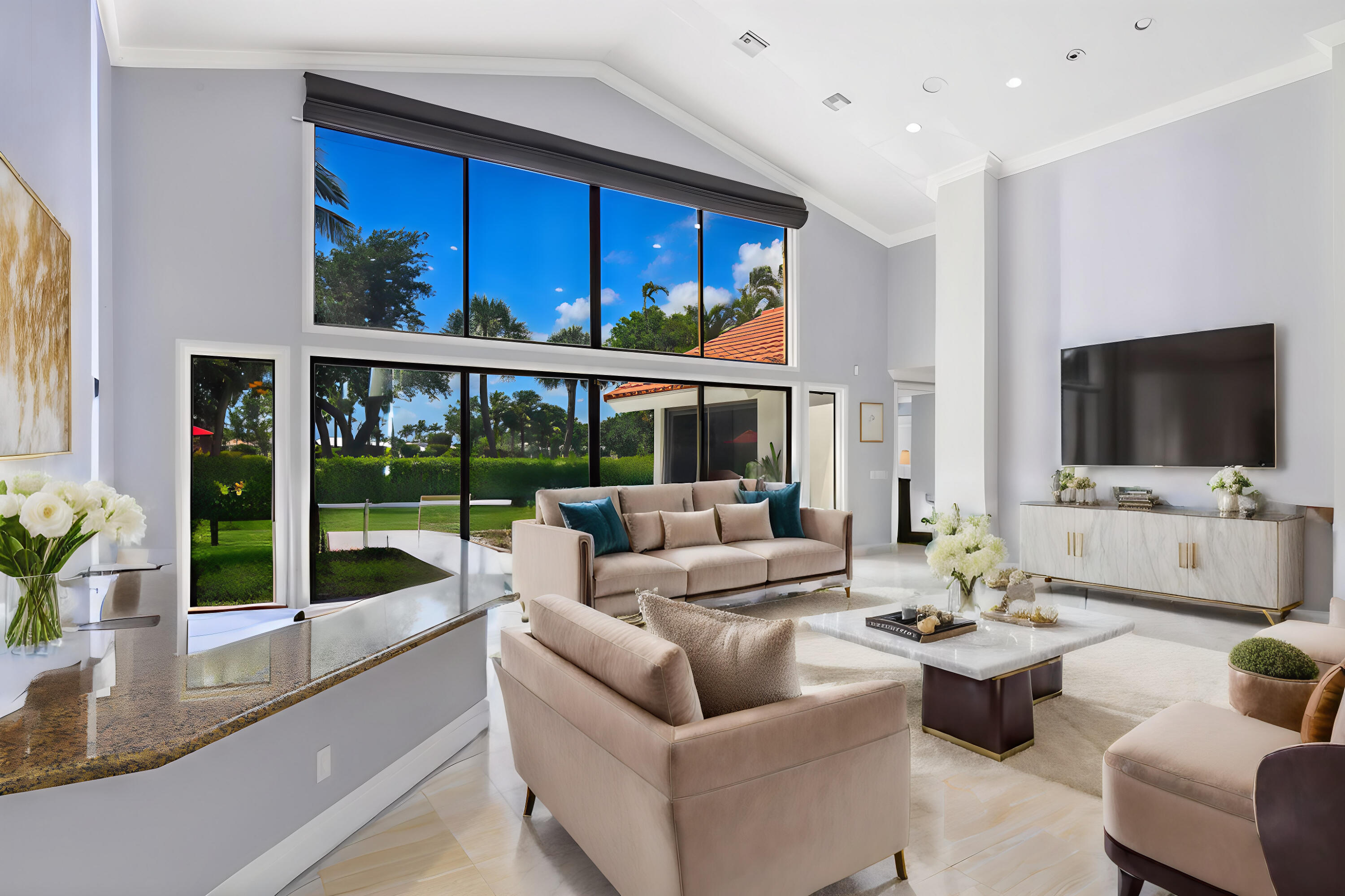4335 Bocaire Boulevard Boca Raton, FL 33487 - Photo 9 of 55 a living room with furniture a flat screen tv and a floor to ceiling window