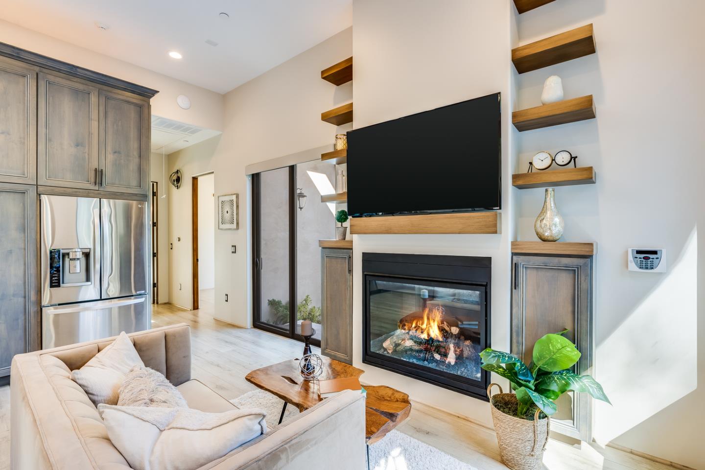 13740 Pierce Road Saratoga, CA 95070 - Photo 13 of 100 a living room with furniture a fireplace and a flat screen tv