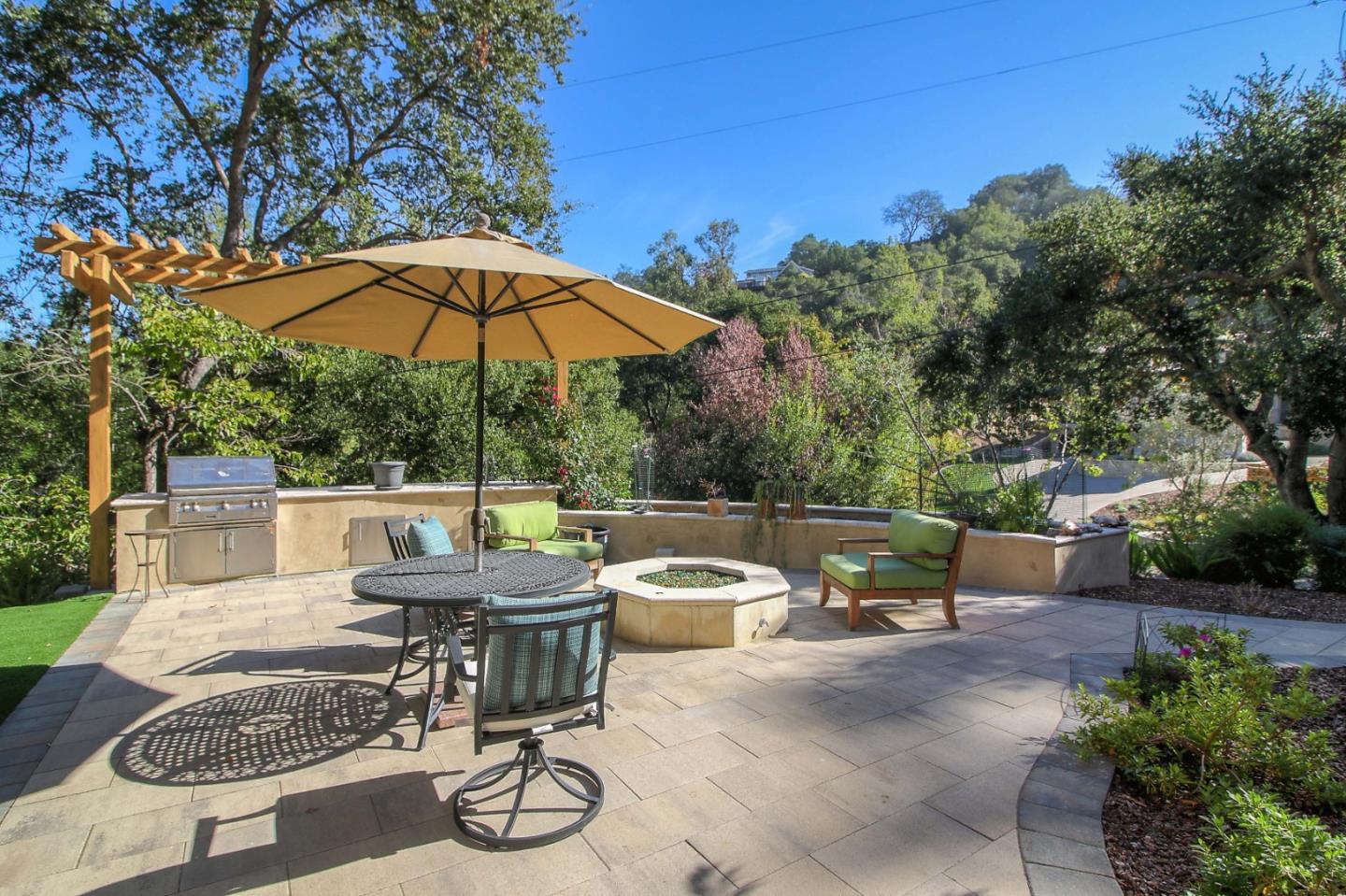 13740 Pierce Road Saratoga, CA 95070 - Photo 30 of 100 a view of patio with couches table and chairs under an umbrella