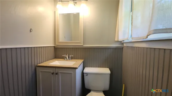 a bathroom with a sink toilet and vanity