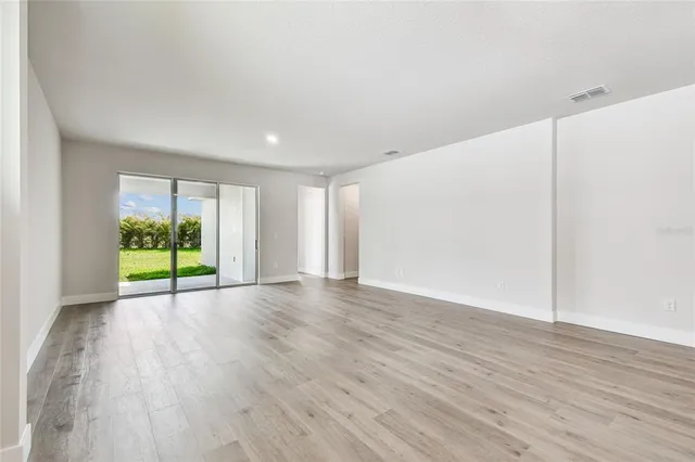 a view of kitchen and hall with wooden floor