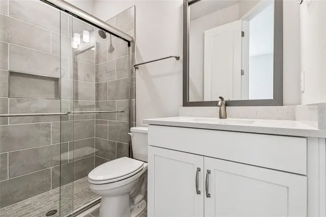 a bathroom with a toilet and a shower