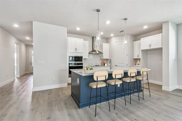 a large kitchen with a large counter top and stainless steel appliances