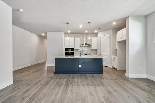 a view of kitchen with granite countertop cabinets and white appliances