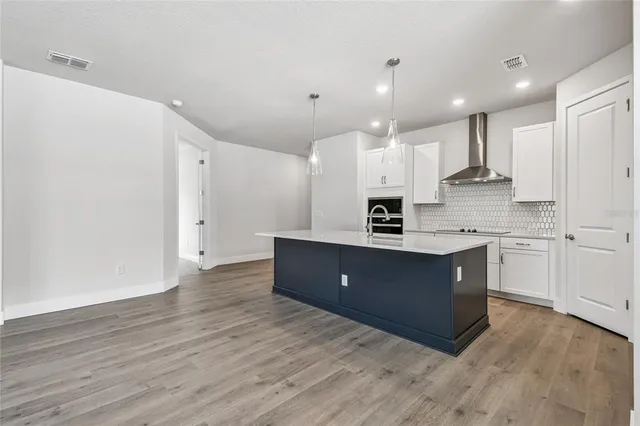 a kitchen with white cabinets and sink