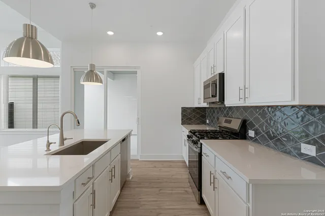a kitchen with a sink stove and microwave